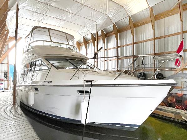 Bayliner 3788 Convertible Sedan 2002 Bayliner 3788 Convertible Sedan docked in a covered marina.