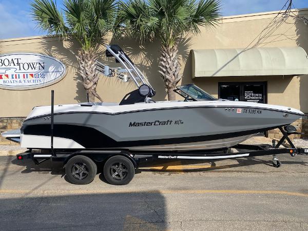 MasterCraft NXT22 2022 MasterCraft NXT22 boat on trailer, parked outside Boat Town dealership.