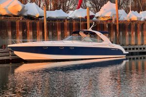 Formula 400 Super Sport 2003 Formula 400 Super Sport boat docked, reflecting on calm water at sunset.