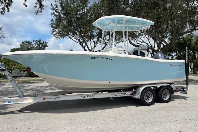 Tidewater 220 CC Adventure 2023 Tidewater 220 CC Adventure boat on trailer, light blue hull, parked outdoors.