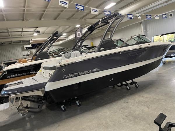 Chaparral 247 SSX 2025 Chaparral 247 SSX boat in showroom, sleek design, modern features.