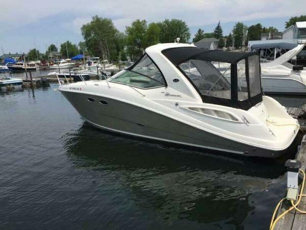 Sea Ray 290 Sundancer 2006 Sea Ray 290 Sundancer boat docked in a marina, side view.