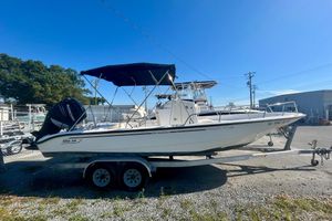 Boston Whaler 220 Dauntless 2005 Boston Whaler 220 Dauntless boat on trailer, parked outdoors under clear blue sky.