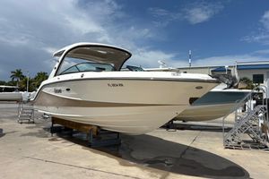 Sea Ray SLX 310 Outboard 2018 Sea Ray SLX 310 Outboard boat on display at a marina under a clear sky.