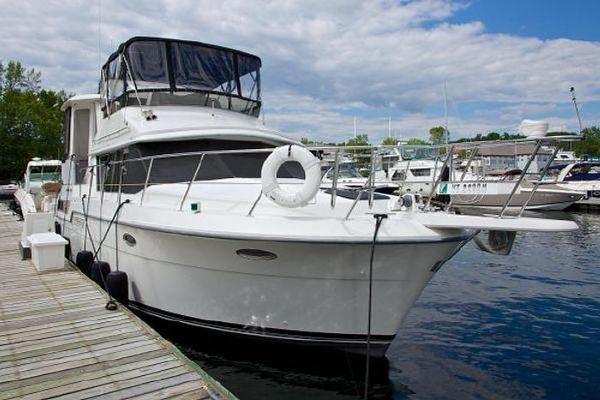 Carver 390 1994 Carver 390 yacht docked at marina under partly cloudy sky.