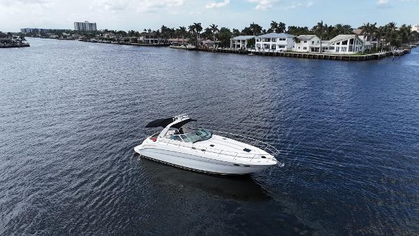 Sea Ray 380 Sundancer 2001 Sea Ray 380 Sundancer yacht cruising on a scenic waterway near luxury homes.