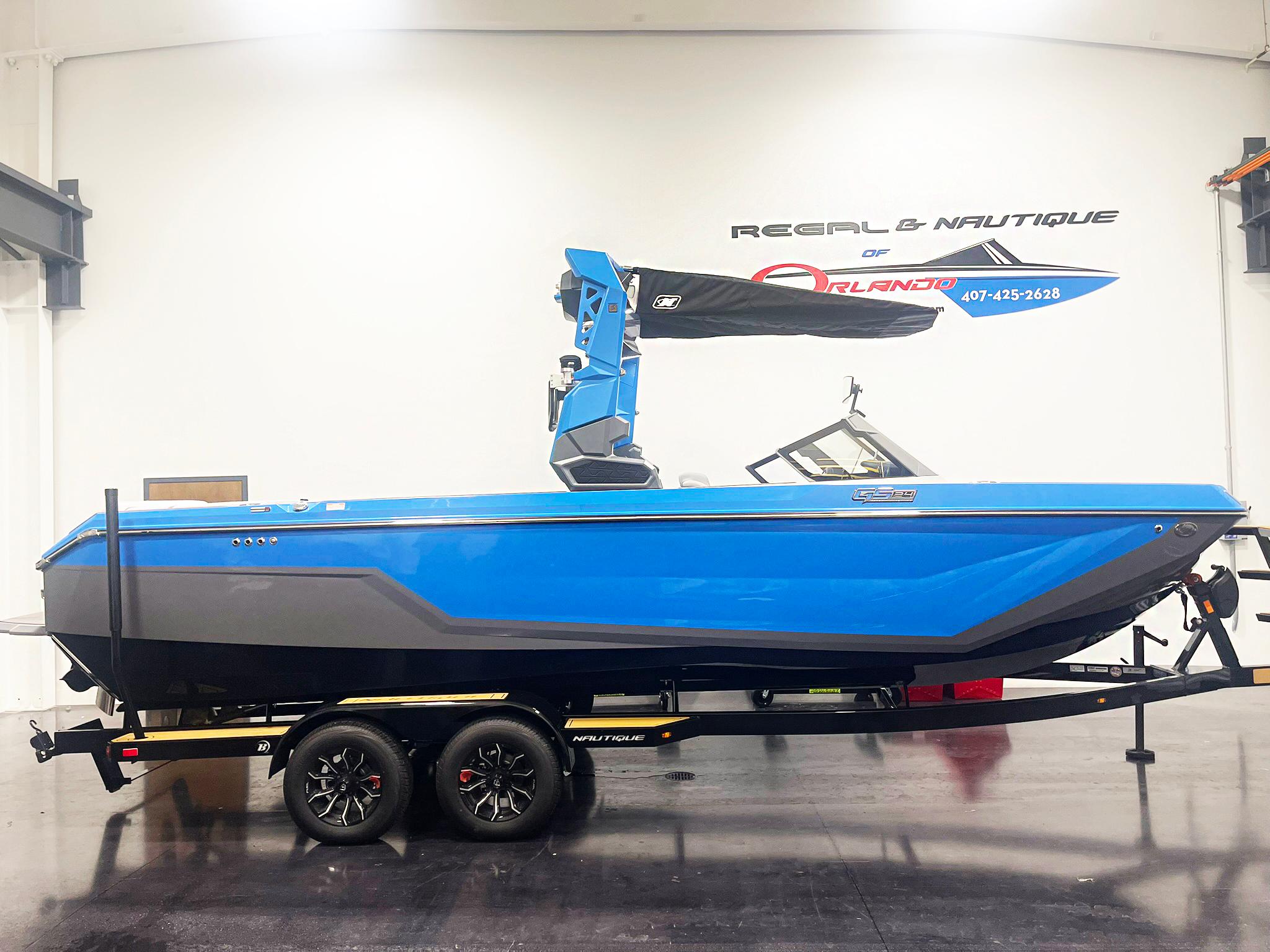 Nautique Super Air Nautique GS24 2025 Nautique Super Air Nautique GS24 boat in showroom, blue exterior, on trailer.