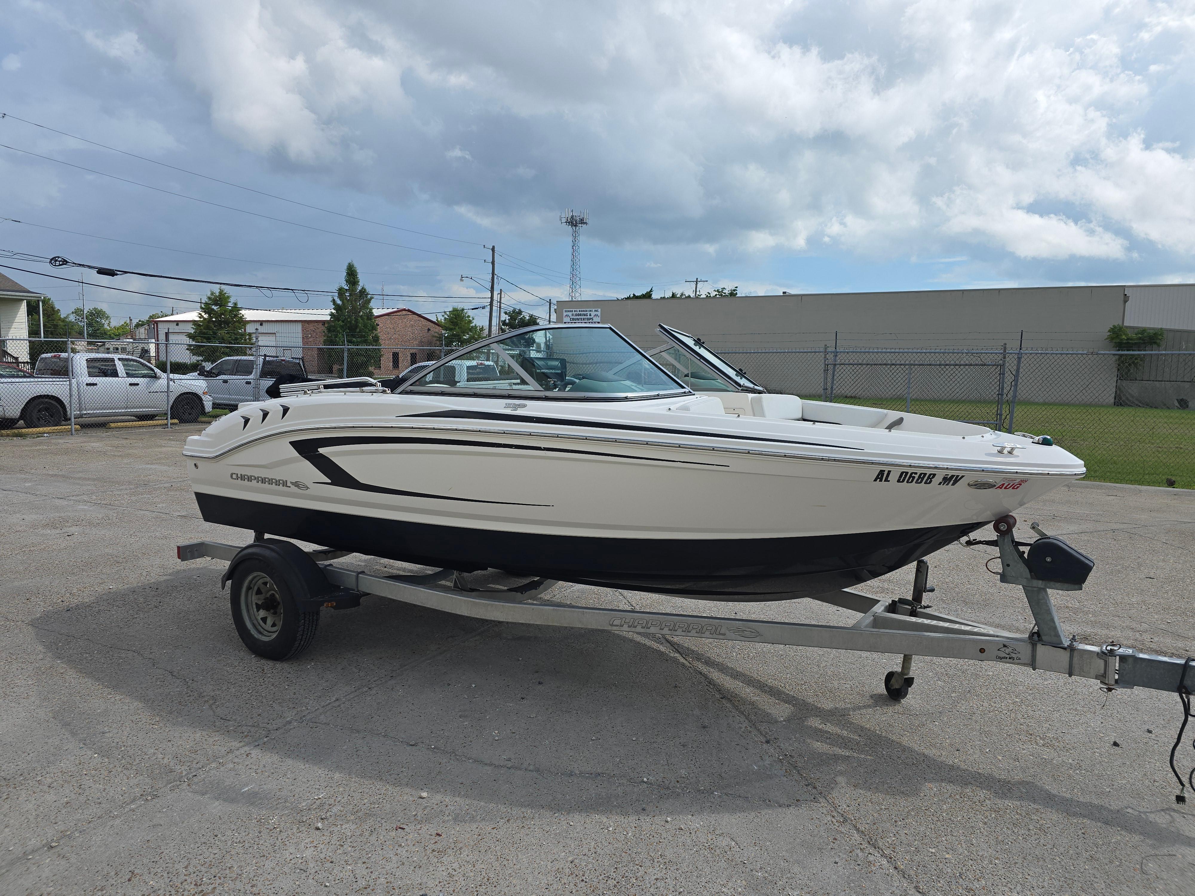 Chaparral 18 H2O Sport 2016 Chaparral 18 H2O Sport boat on trailer, parked outdoors under cloudy sky.