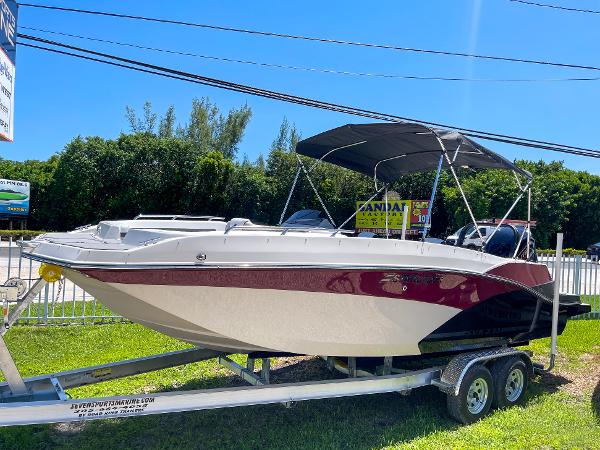 Starcraft SVX 231 OB 2024 Starcraft SVX 231 OB boat on a trailer with a black canopy.