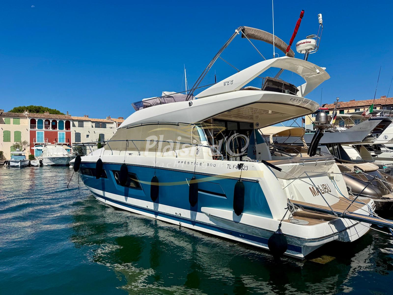 Prestige 500 fly 2016 Prestige 500 Fly yacht docked in a sunny marina, showcasing sleek design and luxury.