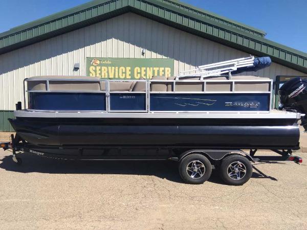 Ranger Reata 200C 2024 Ranger Reata 200C pontoon boat on trailer at service center.