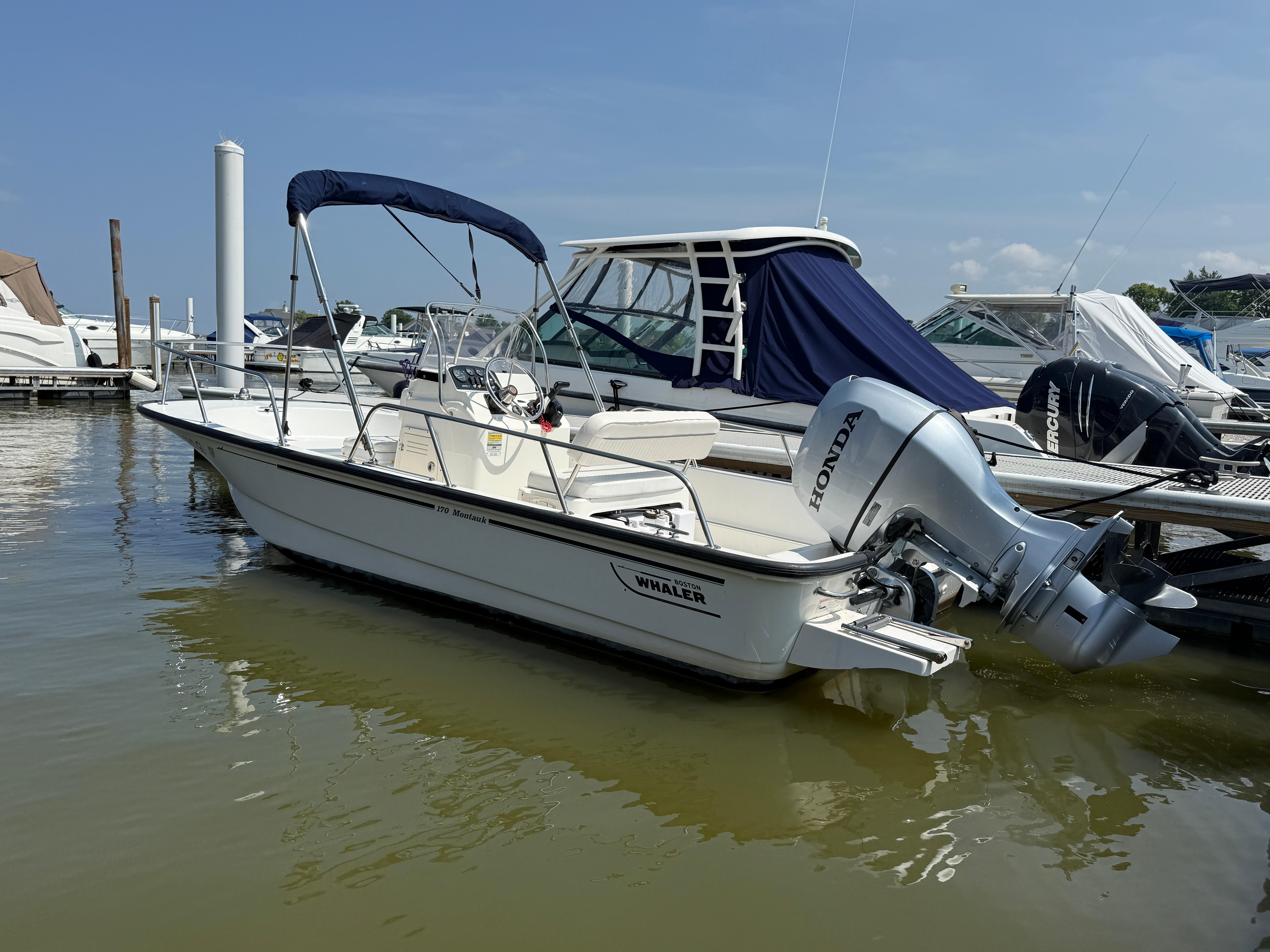 Boston Whaler 170 Montauk 2008 Boston Whaler 170 Montauk boat docked with Honda outboard motor.