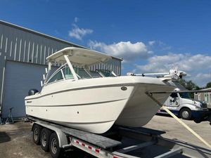 World Cat 230 DC 2021 World Cat 230DC boat on a trailer outside a warehouse.