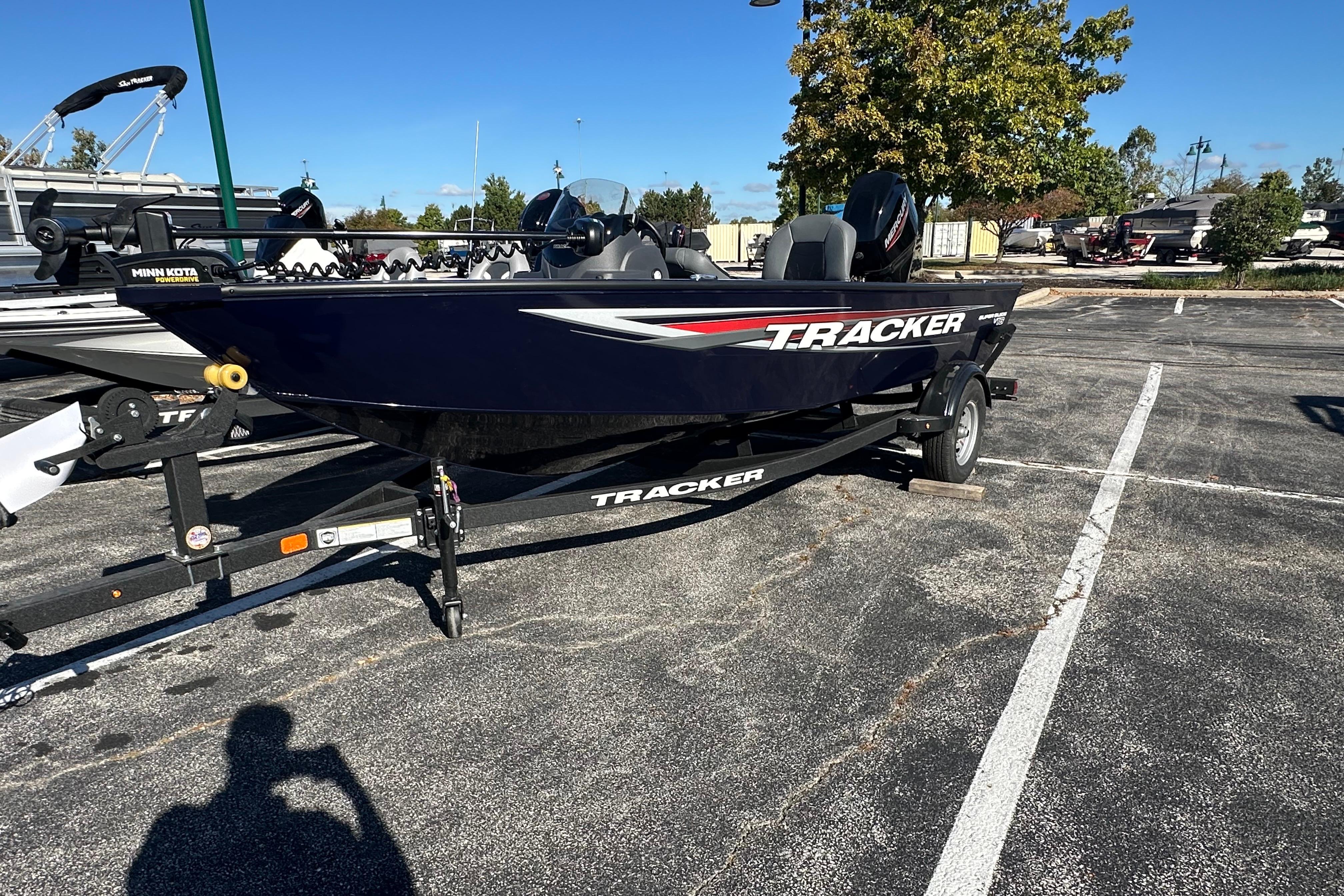 Tracker Super Guide V-16 SC 2026 Tracker Super Guide V-16 SC boat on trailer in parking lot.