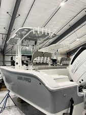 Sea Pro 242 DLX 2024 Sea Pro 242 DLX boat in a warehouse, featuring a Suzuki outboard motor.