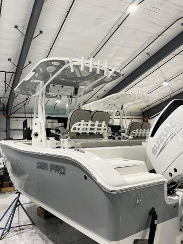 Sea Pro 242 DLX 2024 Sea Pro 242 DLX boat in a warehouse, featuring a Suzuki outboard motor.