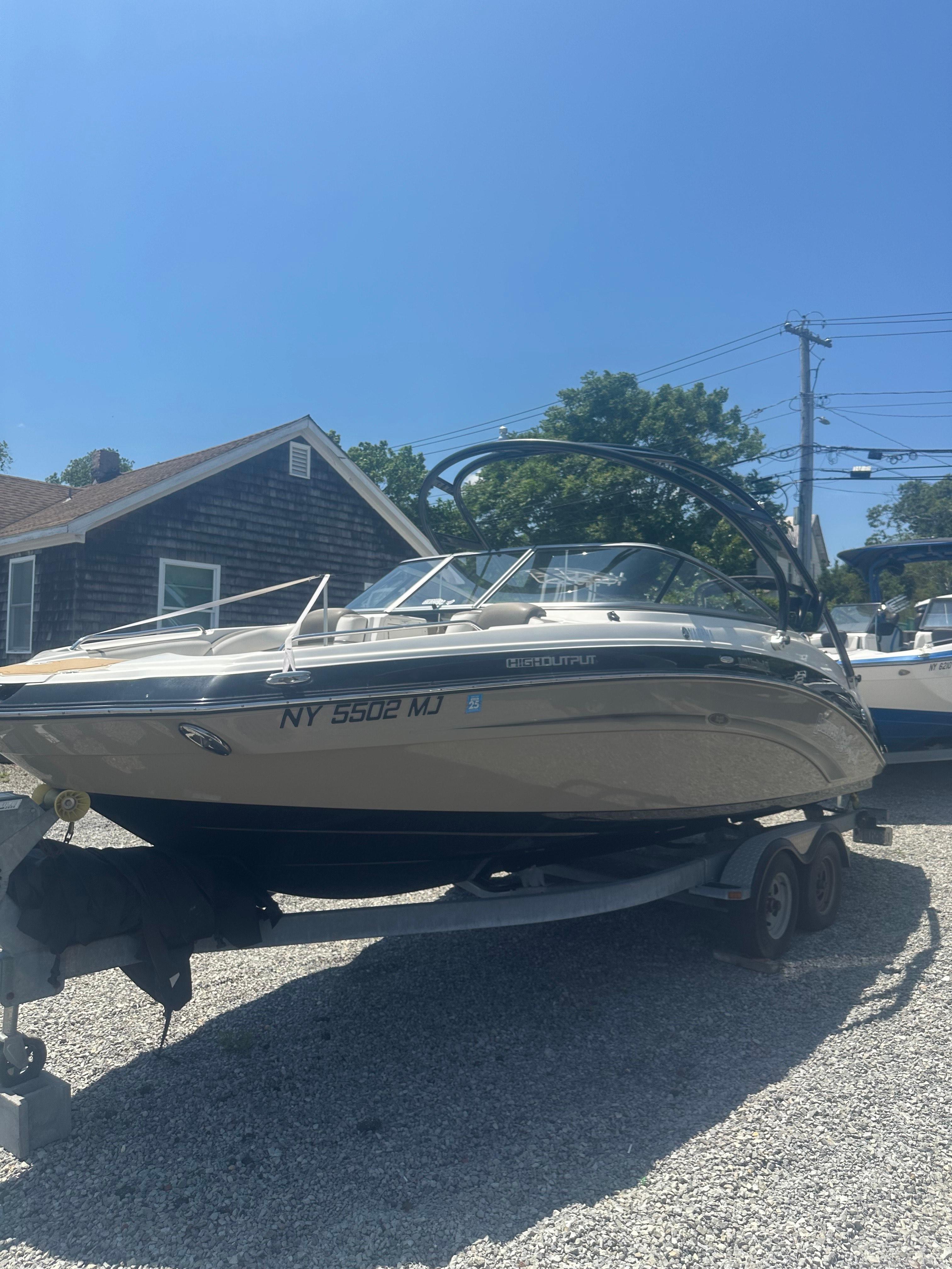 Yamaha Boats 242 Limited S 2013 Yamaha Boats 242 Limited S on trailer, parked outdoors under clear blue sky.
