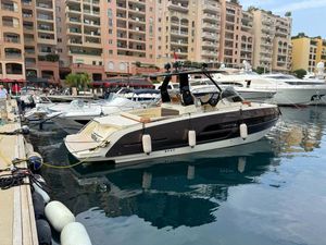 Invictus GT320 Luxury Invictus GT320 yacht docked in marina, 2025 model, with waterfront apartments in background.