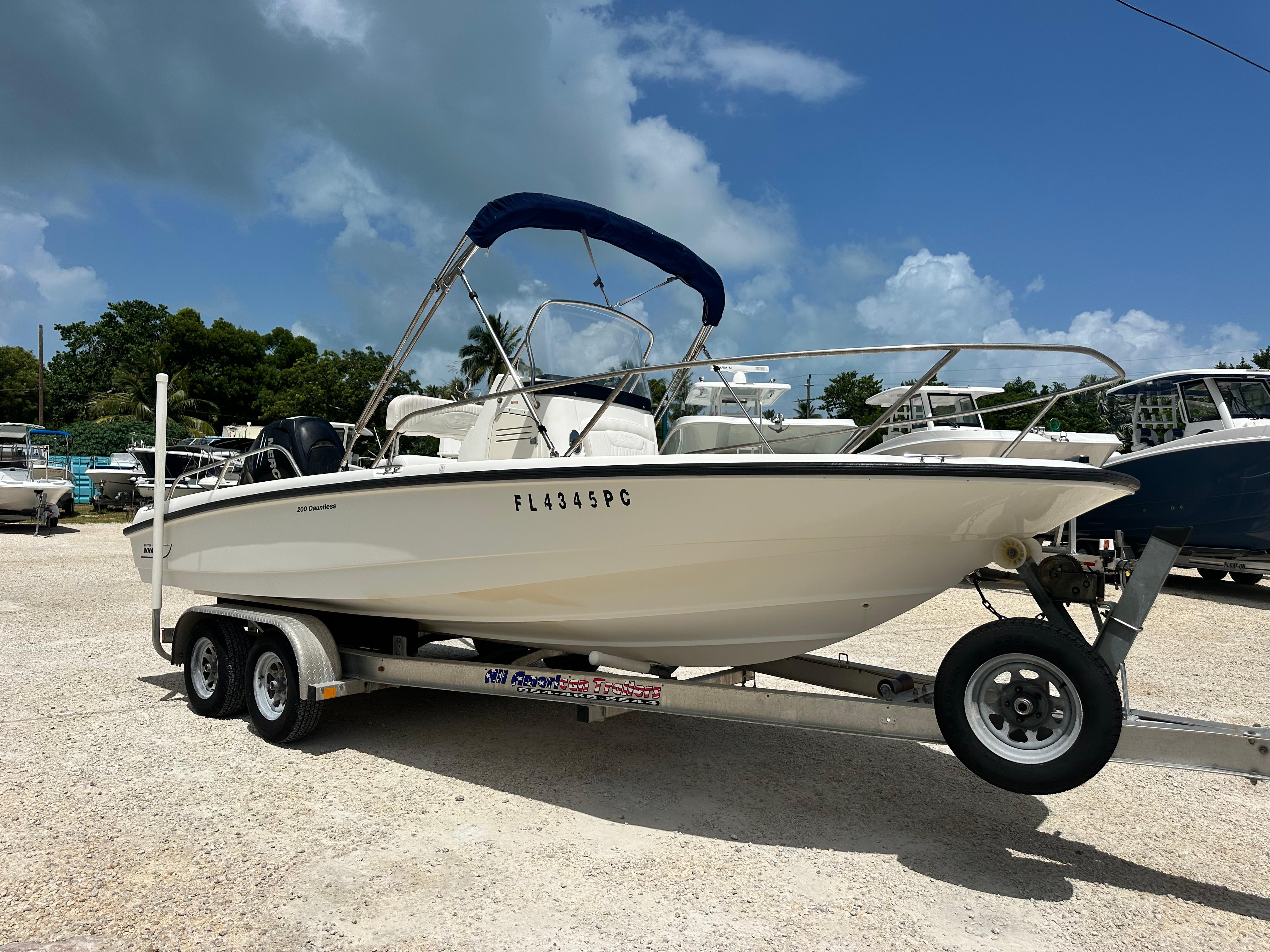 Boston Whaler 200 Dauntless 2010 Boston Whaler 200 Dauntless boat on trailer under blue sky.