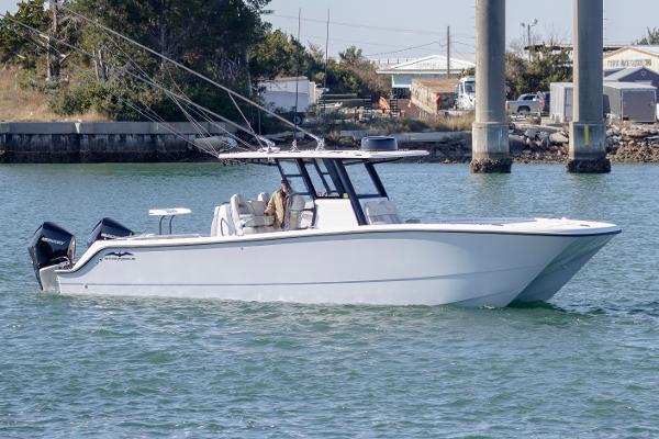 Invincible 33 Catamaran 2022 Invincible 33 Catamaran cruising on water near docks.