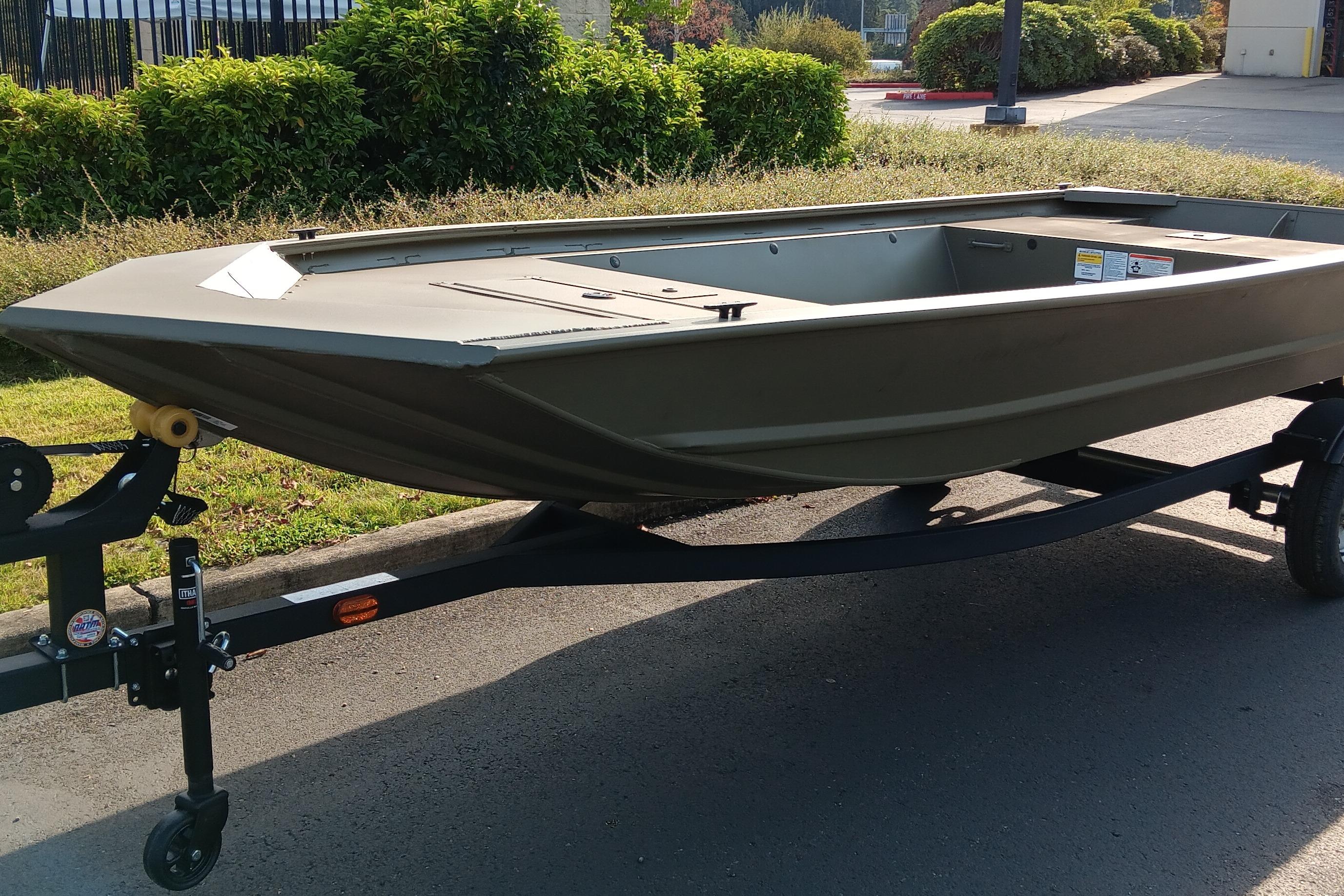 Tracker Grizzly 1648 Utility 2026 Tracker Grizzly 1648 Utility boat on trailer, parked outdoors.