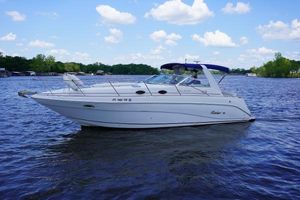 Rinker 330 Fiesta Vee 2000 Rinker 330 Fiesta Vee boat on a calm lake under a blue sky.