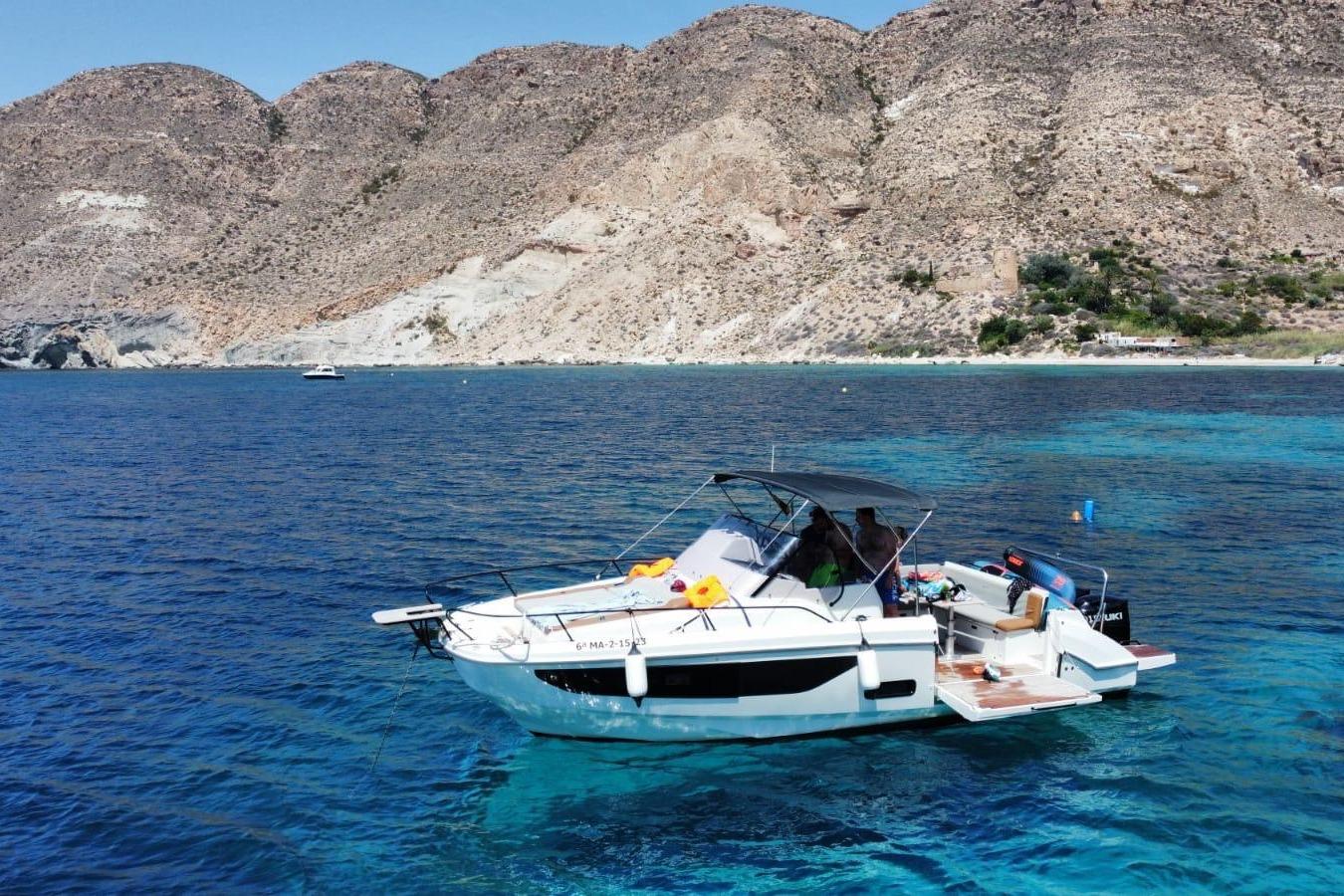 Beneteau Flyer 9 SUNdeck 2023 Beneteau Flyer 9 SUNdeck boat on clear blue water near rocky coastline.