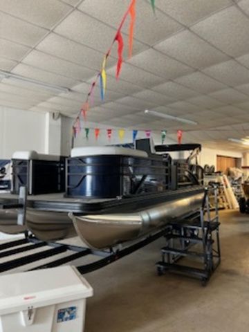 Bennington S Swingback 22 SSB 2026 Bennington S Swingback 22 SSB pontoon boat displayed indoors with colorful flags.