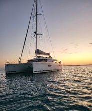 Fountaine Pajot SABA 50 2019 Fountaine Pajot SABA 50 catamaran sailing at sunset on calm waters.