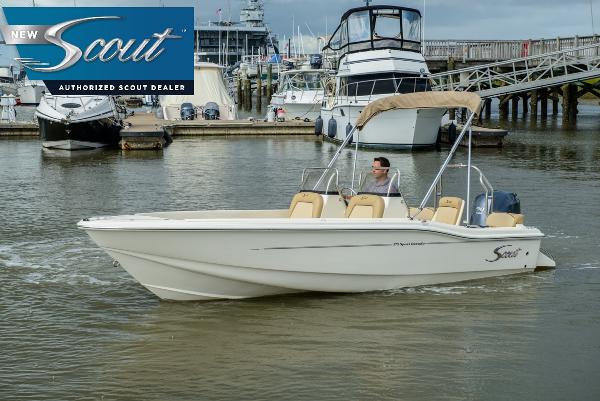 Scout 175 Sport Dorado 2025 Scout 175 Sport Dorado boat cruising in marina, featuring sleek design and beige seating.