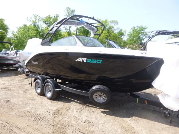 Yamaha Boats AR220 2025 Yamaha Boats AR220 on trailer, sleek black design, parked outdoors.