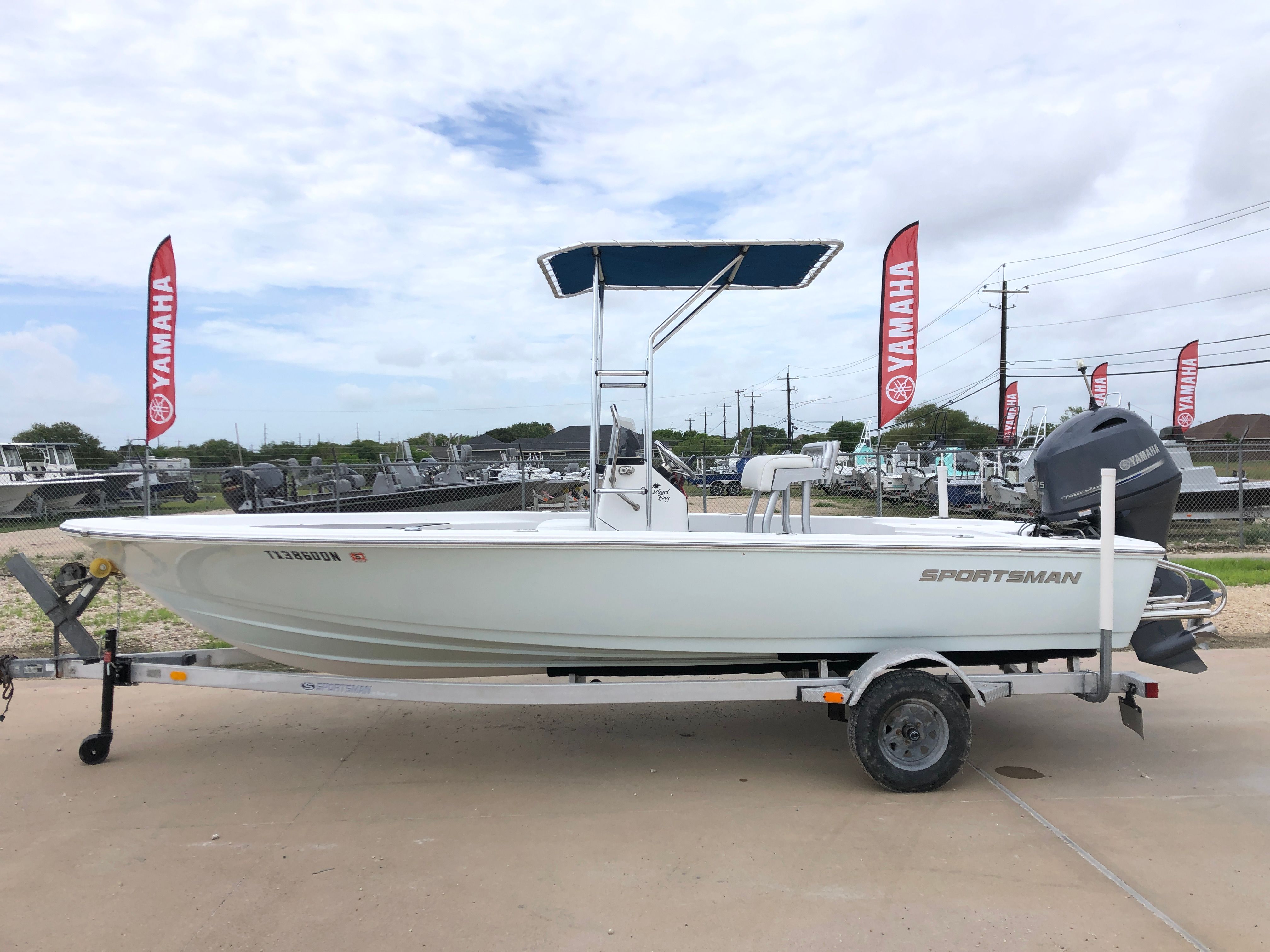 Sportsman 20 Island Bay 2016 Sportsman 20 Island Bay boat on trailer, Yamaha flags in background.
