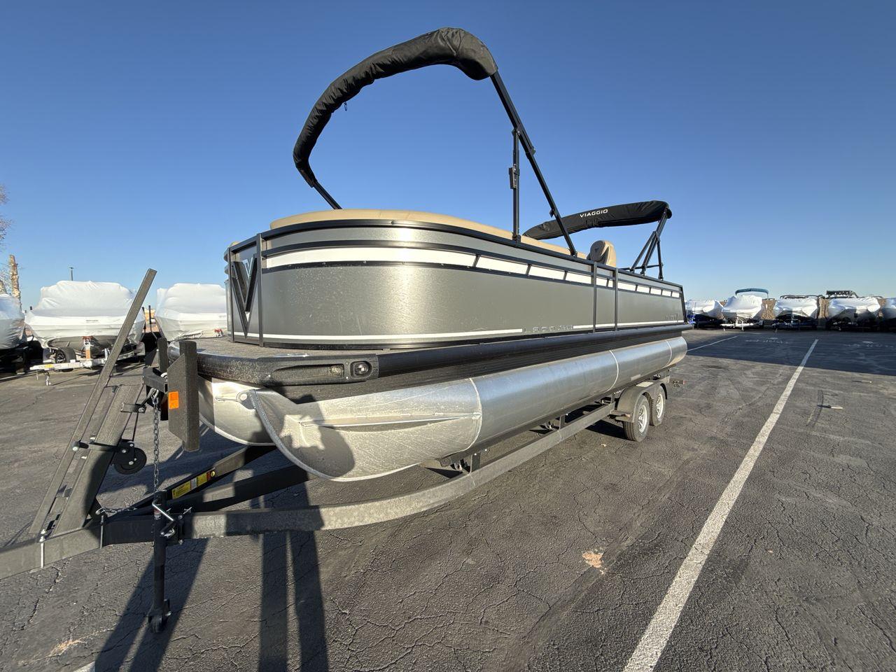 Viaggio x24s 2025 Viaggio x24s pontoon boat on trailer under clear blue sky.