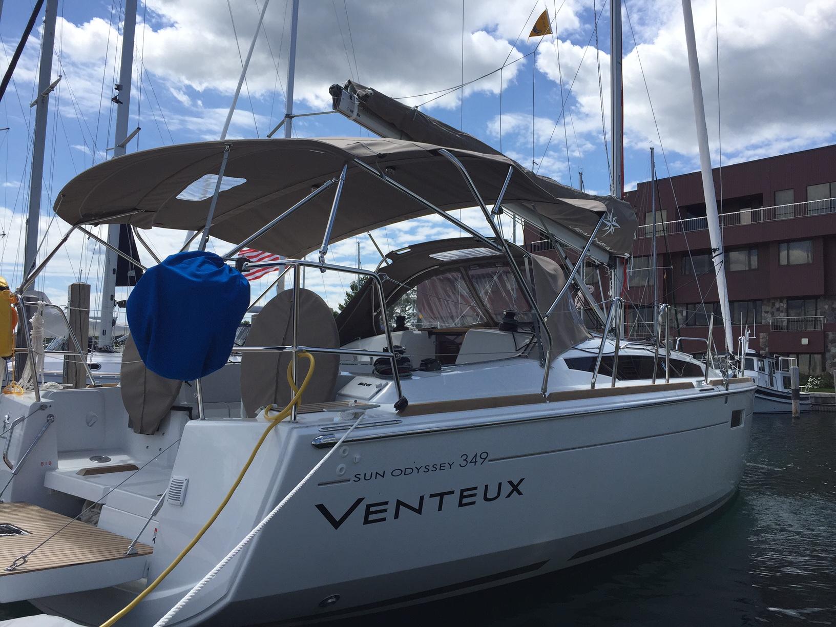 Jeanneau Sun Odyssey 349 2016 Jeanneau Sun Odyssey 349 sailboat docked at marina under cloudy sky.
