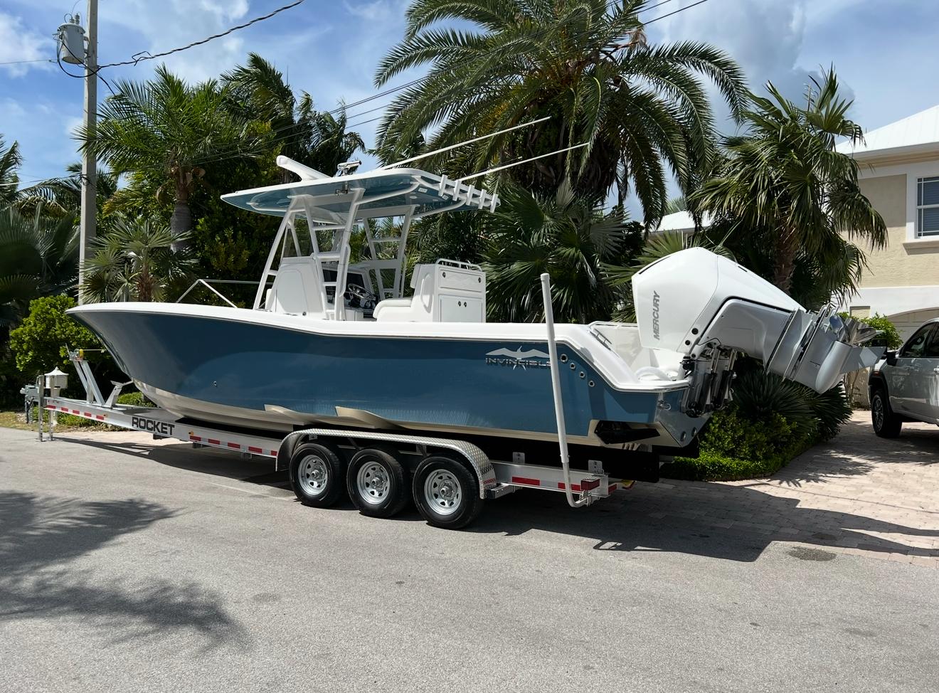 Invincible 33 Open Fisherman 2021 Invincible 33 Open Fisherman boat on trailer, parked near palm trees.