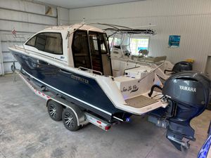Cutwater C-24 Coupe 2022 Cutwater C-24 Coupe boat with Yamaha engine on trailer in indoor storage.