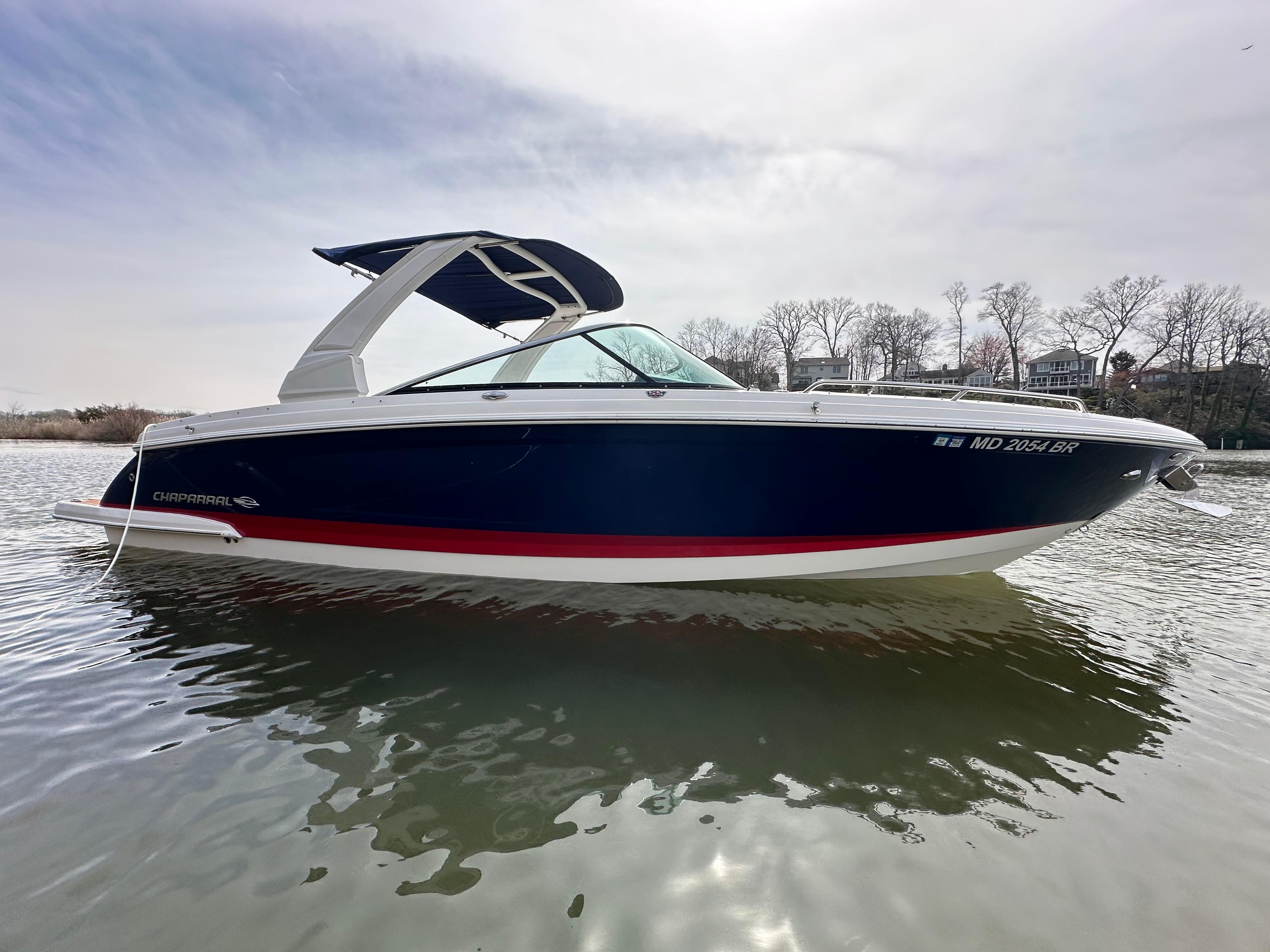Chaparral 297 SSX 2019 Chaparral 297 SSX boat on calm water with a cloudy sky background.