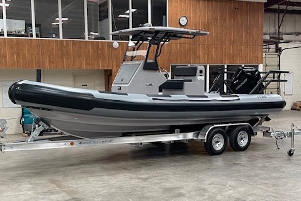 Fluid Watercraft 23 patrol 2025 Fluid Watercraft 23 Patrol boat on trailer in indoor setting.