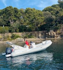 Master 699 A Master 699 boat from 2020 on calm water near a rocky, forested shoreline.