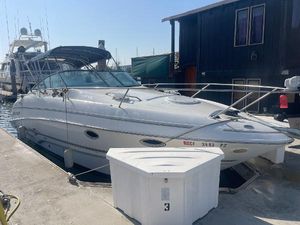 Larson 270 2003 Larson 270 boat docked at marina, featuring sleek design and spacious deck.