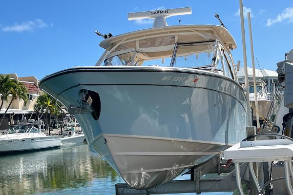 Grady-White Freedom 307 2024 Grady-White Freedom 307 boat docked in a marina under clear blue skies.