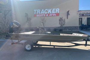 Tracker Grizzly 1860 CC 2026 Tracker Grizzly 1860 CC boat on trailer outside Tracker Boats store.