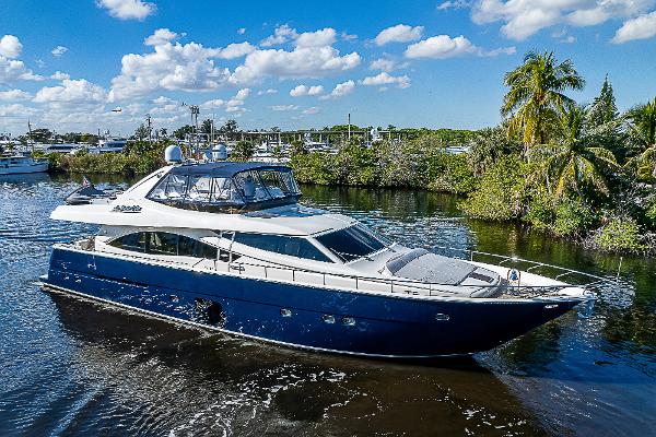 Ferretti Yachts 830 2006 Ferretti Yachts 830 cruising on a scenic waterway under a blue sky.