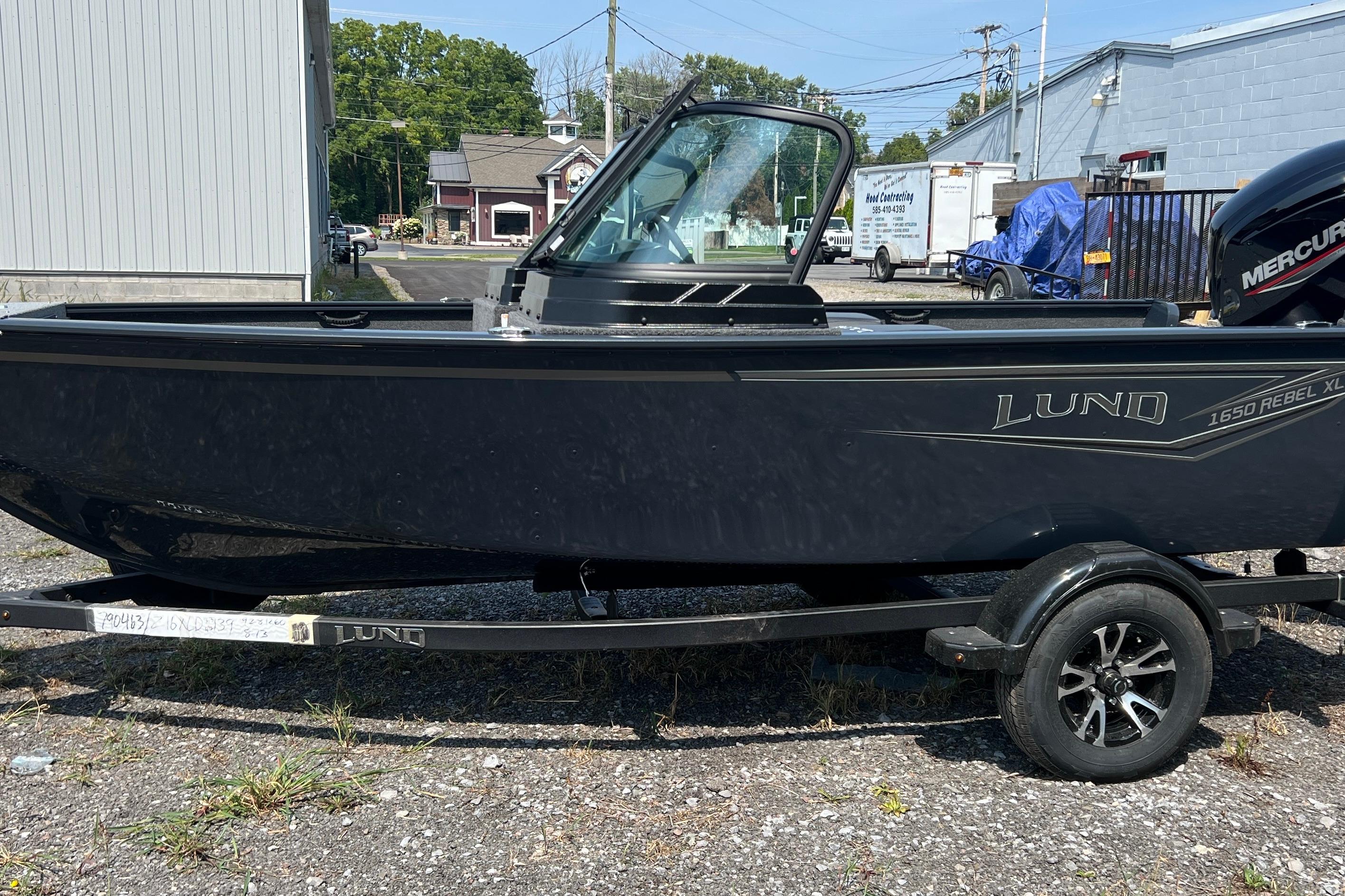 Lund 1650 Rebel XL Sport 2025 Lund 1650 Rebel XL Sport boat on trailer, parked outdoors.