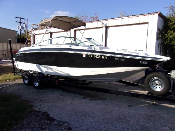 Cobalt 240SD 2004 Cobalt 240SD boat on trailer, black and white design, parked outdoors.