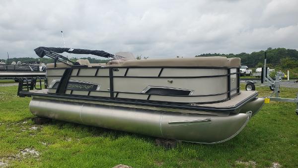 Starcraft EXS 1 2025 Starcraft EXS 1 pontoon boat on grassy area under cloudy sky.