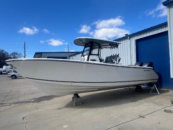 Cobia 285 Open Center Console 2025 Cobia 285 Open Center Console boat on display outside a warehouse.