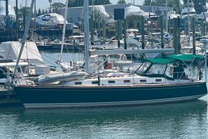 Tartan 4100 Sailboat docked in marina, Tartan 4100 model, 2001, with green canopy.