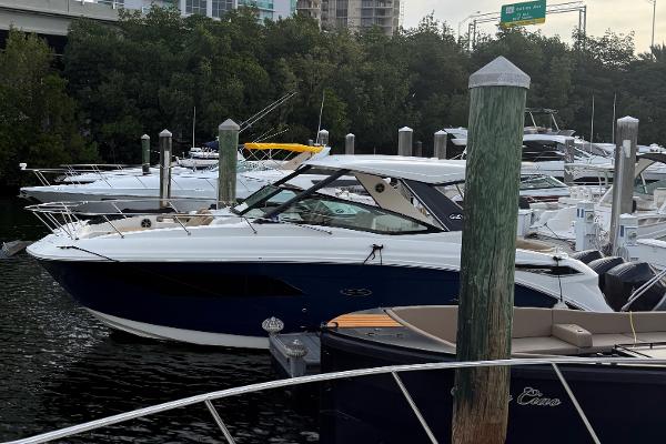Sea Ray Sundancer 320 Coupe Outboard 2021 Sea Ray Sundancer 320 Coupe OB docked in a marina, surrounded by other boats.