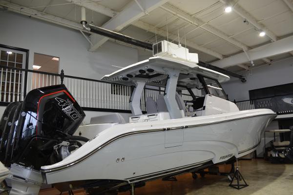 Fountain 43SCX 2025 Fountain 43SCX boat in showroom, featuring sleek design and powerful engine.
